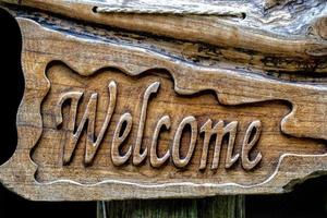 Welcom sign carved on wood photo