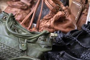 many leather woman bags at the market photo