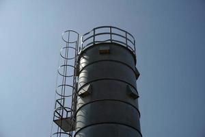 metallic silos on light blue sky photo