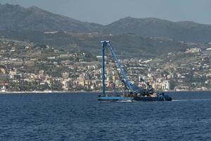 Harbor port dredge working on sea photo