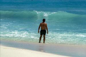 man in front of sea wave photo