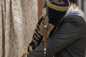 rabbi holding torah scroll book close up photo