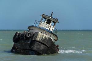 tug ship boat wreck near the beach photo