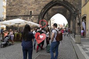 PRAGUE, CZECH REPUBLIC - JULY 15 2019 - Charles Bridge is full of tourist in summer time photo