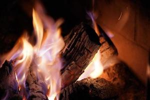 Flames on wood in fireplace photo