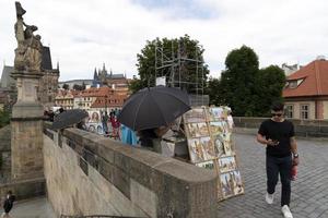 PRAGUE, CZECH REPUBLIC - JULY 15 2019 - Charles Bridge is full of tourist in summer time photo