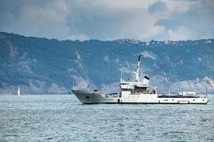 destroyer war ship in action for migrants boat photo