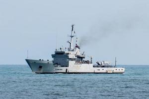 destroyer war ship in action for migrants boat photo