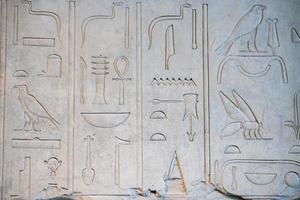 ancient hieroglyphs on stone detail photo