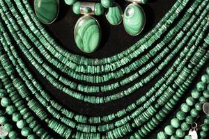 Malachite necklage earrings jewelry on display stand in a shop market photo