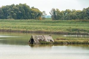 comacchio valley fisherman house on cloudy sky background photo