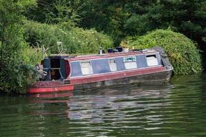 rusty rugged ship in thames river photo