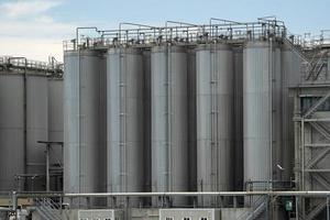 metallic silos on light blue sky photo