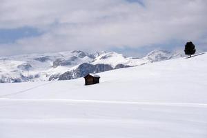 A wood cabin hut in the winter snow background photo