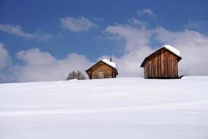 wood cabin hut in the winter snow background photo