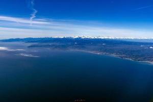 Liguria coast with snowy alps aerial panorama photo