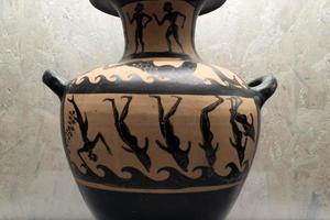 NAPLES, ITALY - FEBRUARY 1 2020 - Swimmer morphing to dolphin greek vase photo