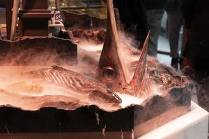 seafood for sale at the market on smoking ice photo