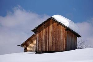 wood cabin hut in the winter snow background photo