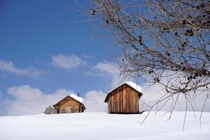 wood cabin hut in the winter snow background photo