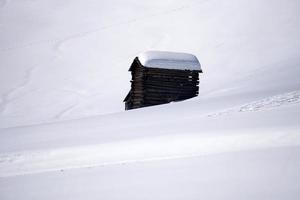 wood cabin hut in the winter snow background photo