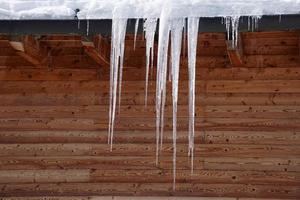 icicles in winter dolomites mountains hut photo