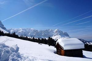 dolomites snow panorama big landscape hut covered by snow photo