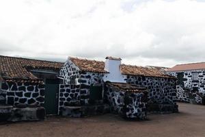 Lajido village Pico Island Azores black lava houses red windows photo