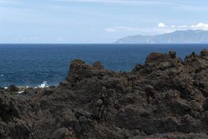 Lajido village Pico Island Azores black lava houses red windows photo