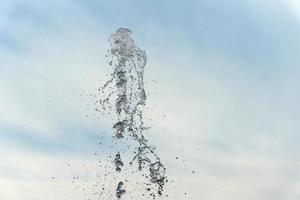 water spurt detail isolated on sky photo