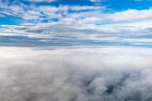 clouds in the sky from airplane window photo