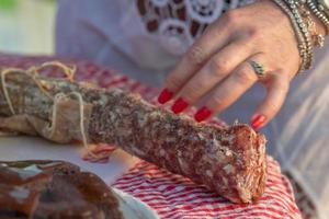 woman hands cutting salami photo