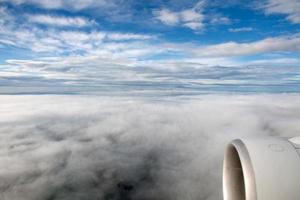 clouds in the sky from airplane window photo