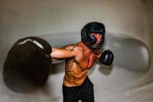 male boxer european while throwing a punch photo