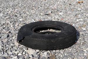 abandoned tire on the beach photo