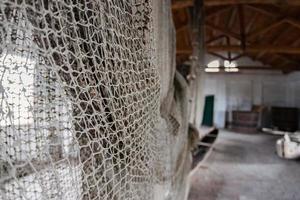 handmade old fishing net inside fisherman house photo