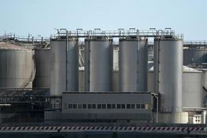 metallic silos on light blue sky photo