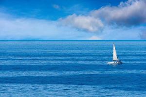 sailboat on deep blue sea photo