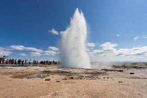 Geyser blow in Iceland while blowing water photo