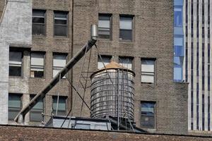 Water tank on new york skyscrapers roof photo