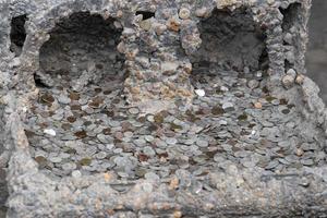 pompei ruins houses full of tourist coins photo