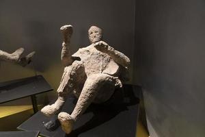 NAPLES, ITALY - FEBRUARY 1 2020 - pompei ruins statue buried corpse photo