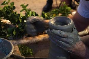 Hands working on pottery closup detail photo