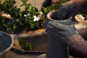 Hands working on pottery closup detail photo