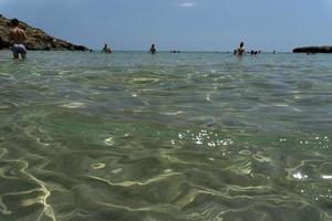 NOTO, ITALY - JULY 18 2020 - Calamosche beach full of people with no social distancing after coronavirus quarentine photo