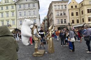 PRAGUE, CZECH REPUBLIC - JULY 16 2019 - Old town square full of tourist street artist is acting as pirate photo