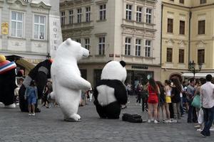 PRAGUE, CZECH REPUBLIC - JULY 16 2019 - Old town square full of tourist street artist acting as big puppet photo