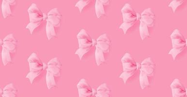 Realistic yellow 3d bows on a pink background vector