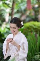 Beautiful girl is in garden and drinking  tea photo