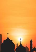 Silhouette Mosque domes against sunrise sky in the morning with beautiful orange sunlight in Iftar period during Ramadan Holy month photo